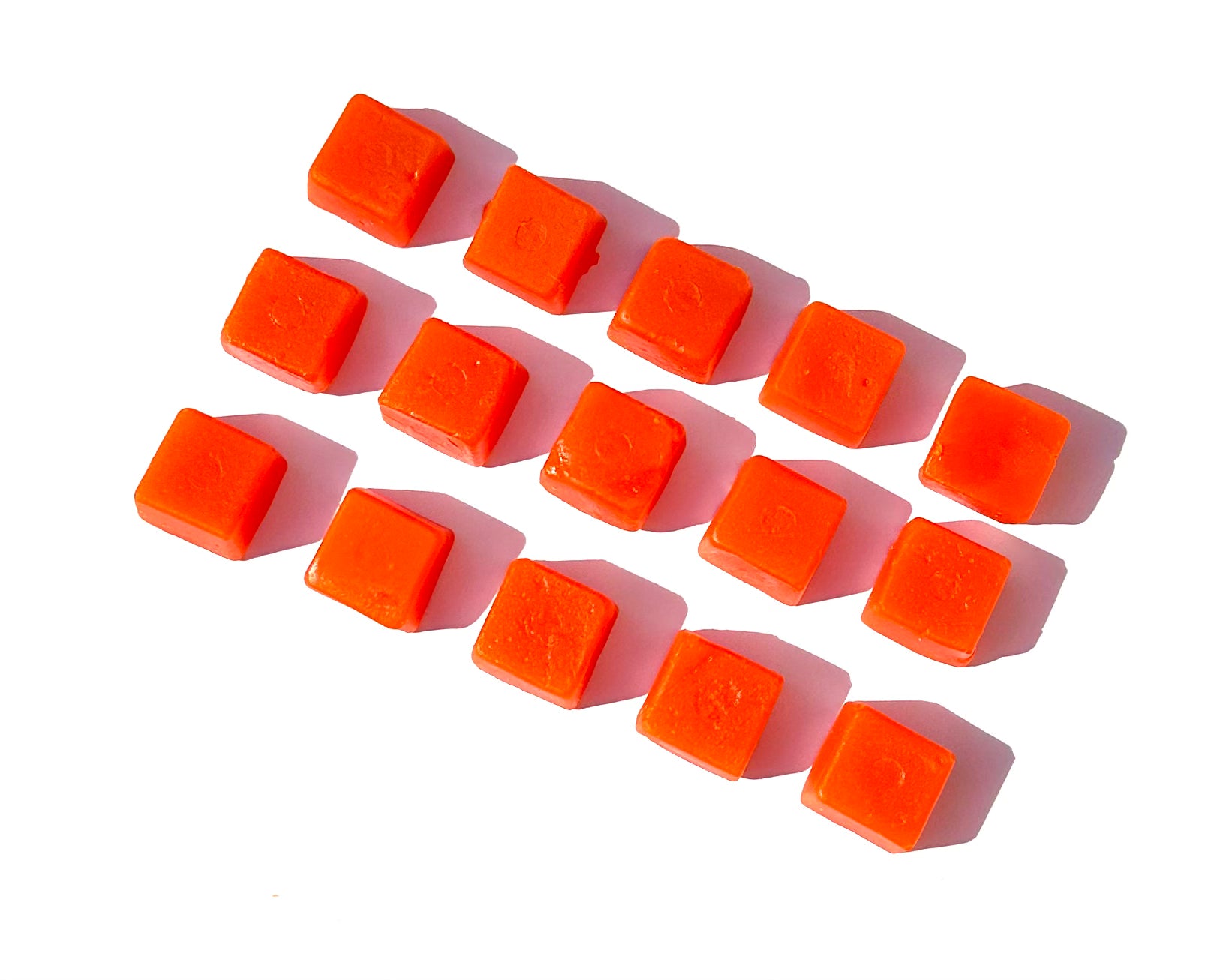 Close-up of individual square orange Afterglo gummies arranged in a grid on a white background.