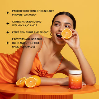 Woman holding an orange with a jar of 'Afterglow' product on a yellow background